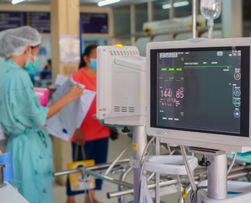 Vital monitor with nurse in background